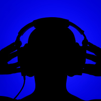 Silhouette of man with headphones on blue background.