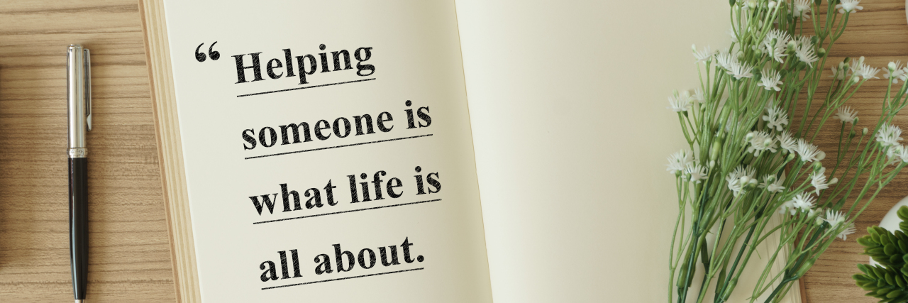 A notebook with an inspirational quote about helping people.