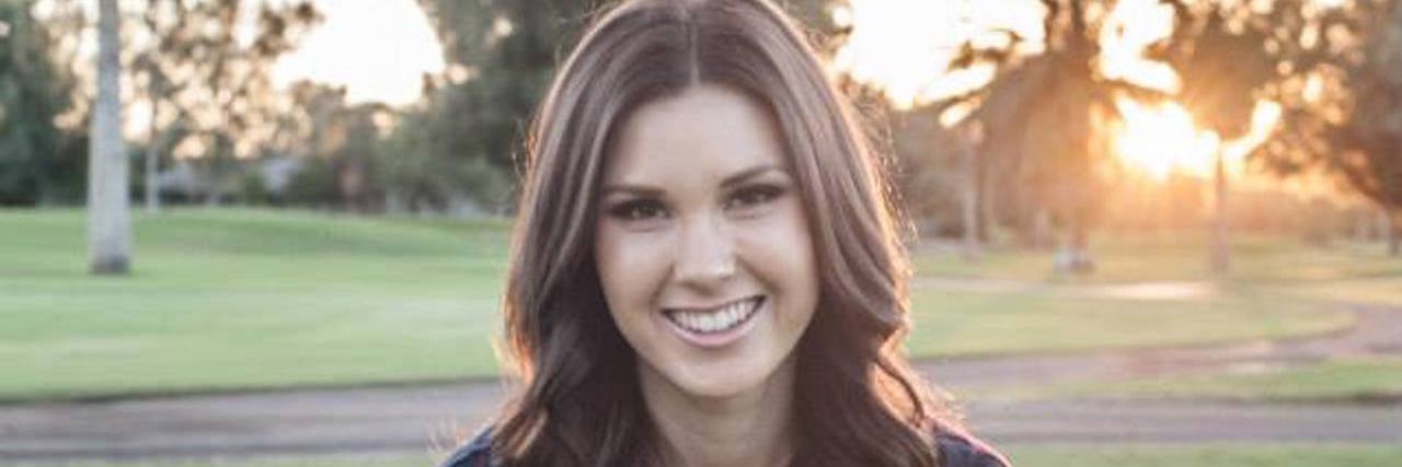 4 Ways People Have Shown Unconditional Kindness With My Lyme Disease A picture of the writer sitting on grass, smiling.