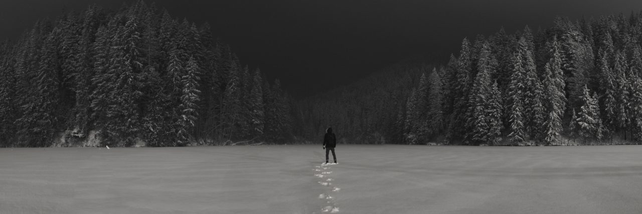 What Suicidal Thoughts Really Feel Like man on snowy field with forest in background at night with clouds