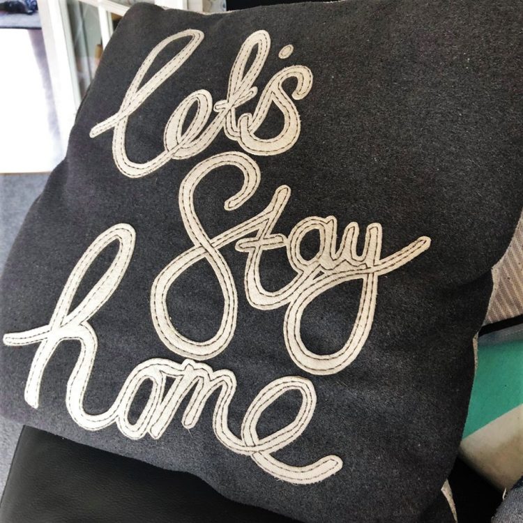 cushion reads: Let's stay home