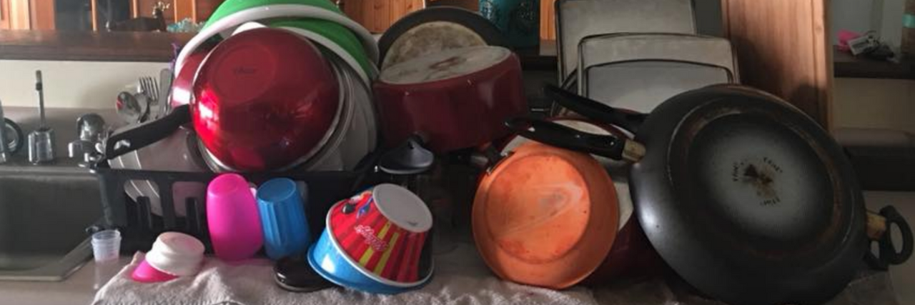 Facebook Post of Clean Dishes Shows How Depression Presents A pile of dishes next to a kitchen sink