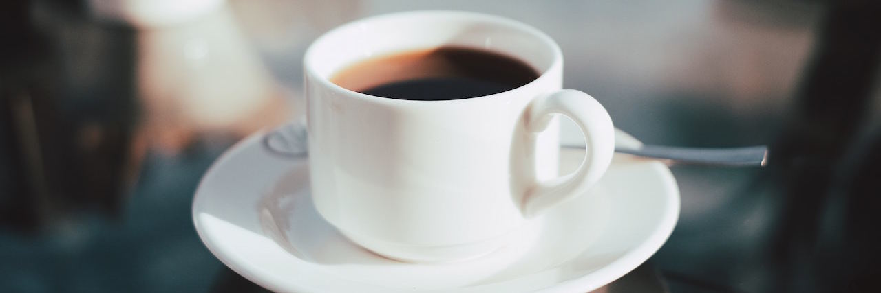 Metaphor: Grief Is Like a Cup of Coffee coffee in a white cup, placed on a glass table