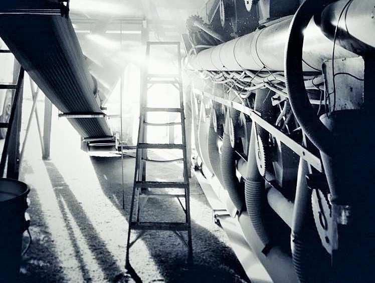 A black and white image showing a ladder, and light and shadows.
