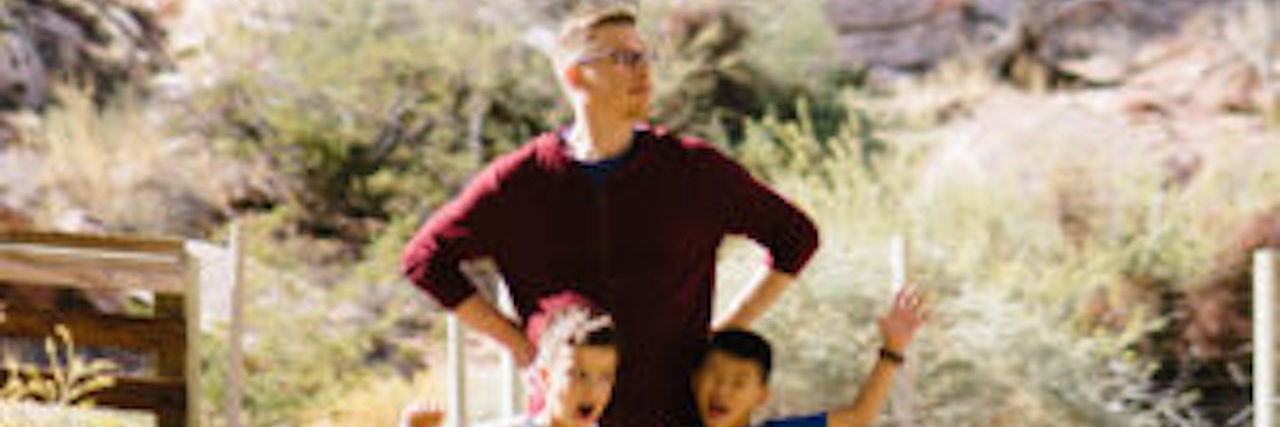 Dad posing with two kids