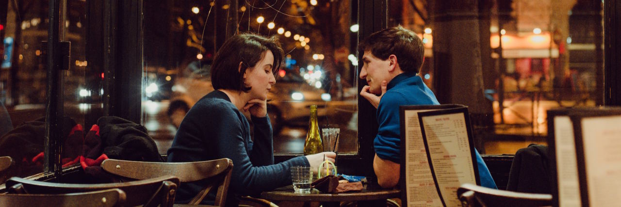 What It's Like to Date When You Have Depression man and woman on a dinner date at night