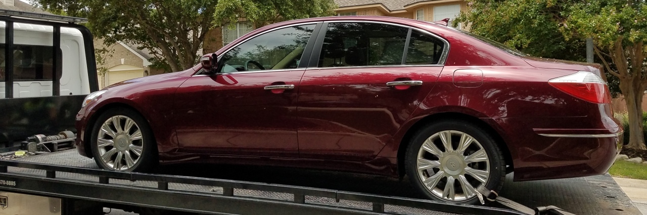 What I Realized About Life With MS When My Car Died A picture of the writer's red car being towed away.