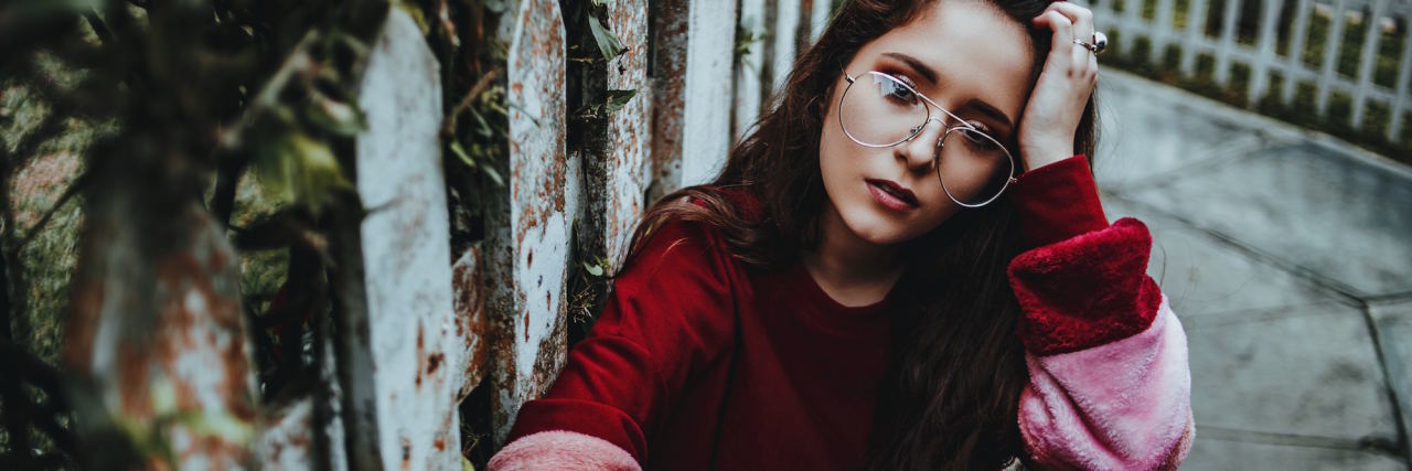 The Reality of Living With 'Anorexia Nostalgia' woman with head on hand