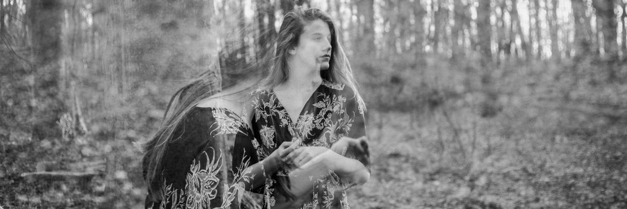 How to Live With Chronic Suicidality as a Complex Trauma Survivor black and white photo double exposure of woman in woods