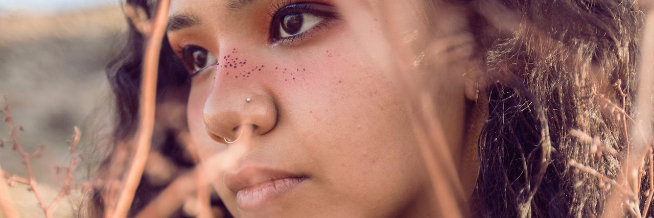 Native and Bipolar a woman behind grass