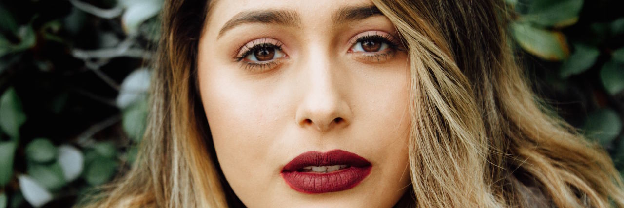 Borderline Personality Disorder Makes Me Feel 'Too Much' All the Time woman with red lipstick