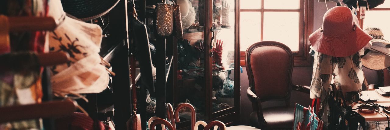 Why I Hold Onto Objects With Emotional Value cluttered room filled with hats and other objects