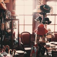 cluttered room filled with hats and other objects