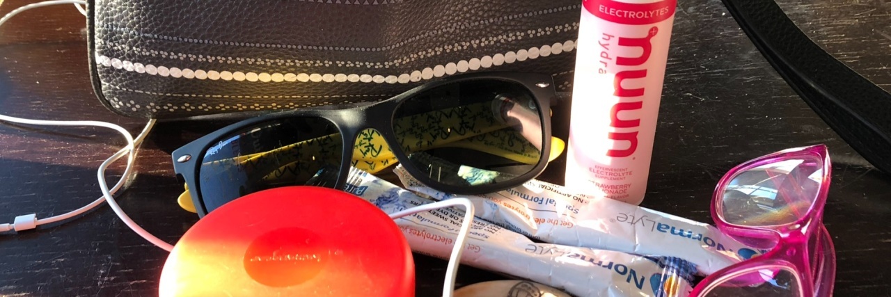Different items placed outside of a purse.