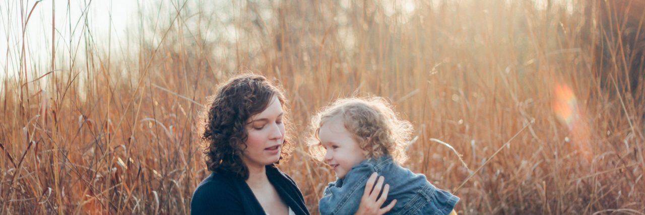 How to Help Your Child With Klippel-Trenaunay Syndrome (KTS) mom holding daughter in a field