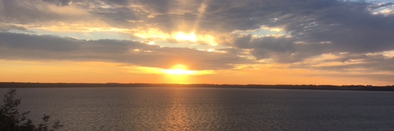 How Watching the Sunrise Helps Me Cope With Chronic Pain sunrise over the lake
