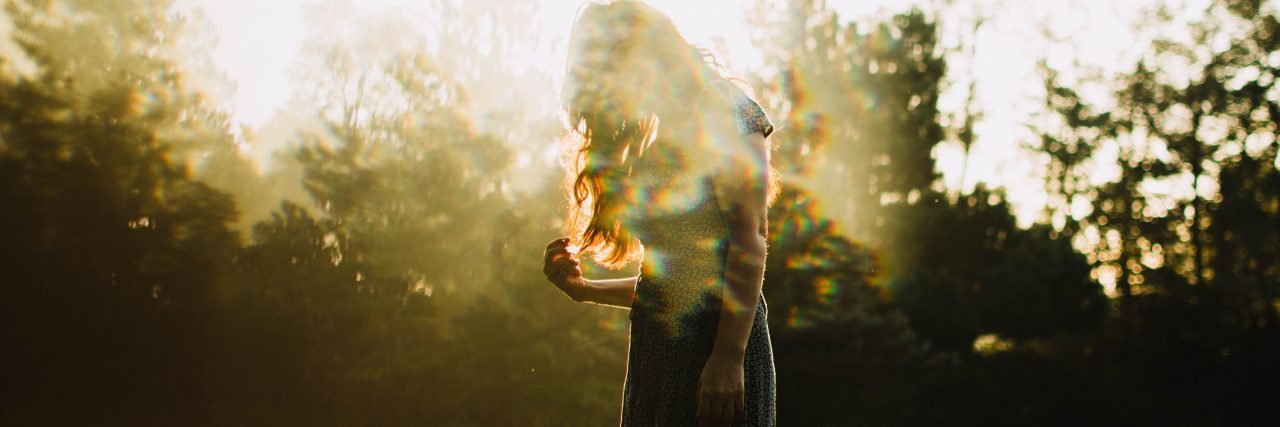 double exposure of woman in sunlight with trees