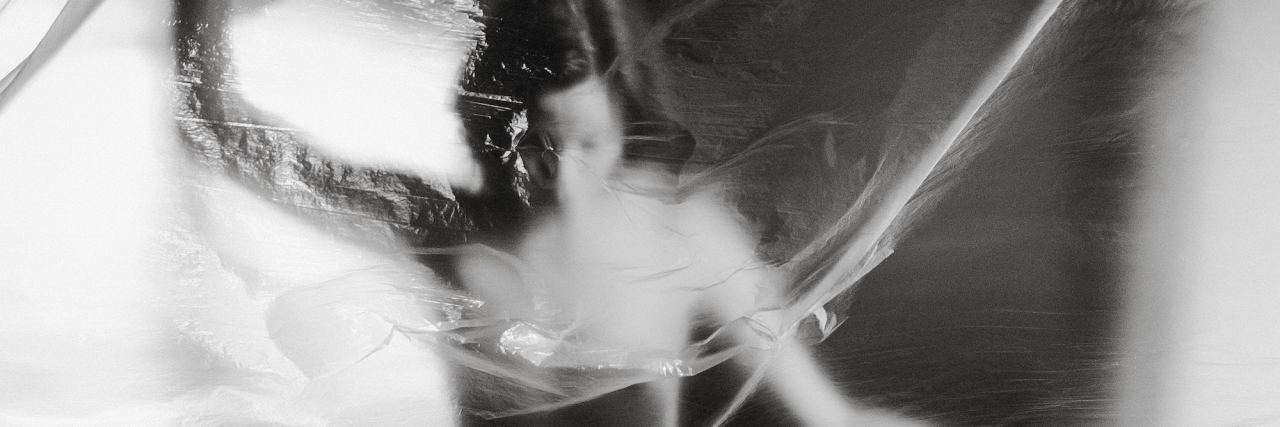 Why I Have Complicated Feelings About Sex as an Abuse Survivor artistic photo of a naked woman behind saran wrap