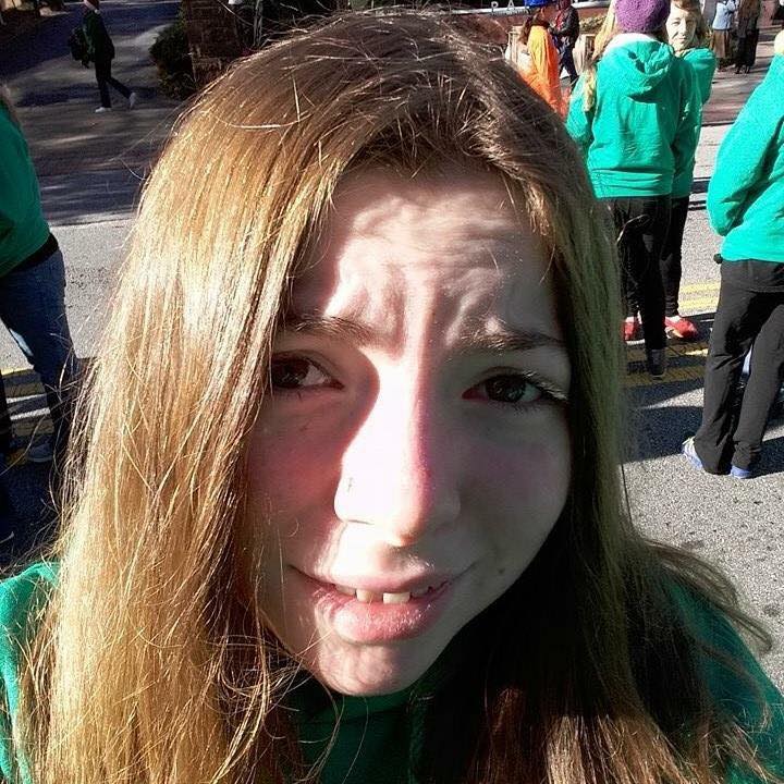 woman taking a selfie at a parade