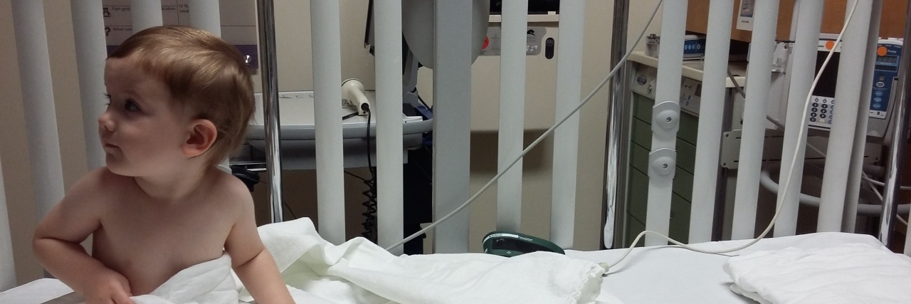 Before I Became a Mom to a Medically Complex Child Boy in hospital bed sitting up looking to the side