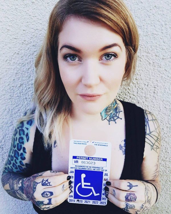 woman holding her disabled parking placard