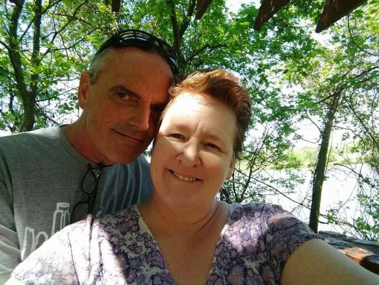 woman and man selfie outside in front of trees