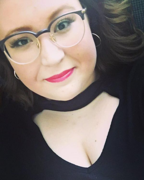 woman wearing black top and glasses