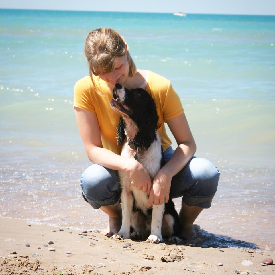 Lara on the beach with her Springer Spaniel Grainger