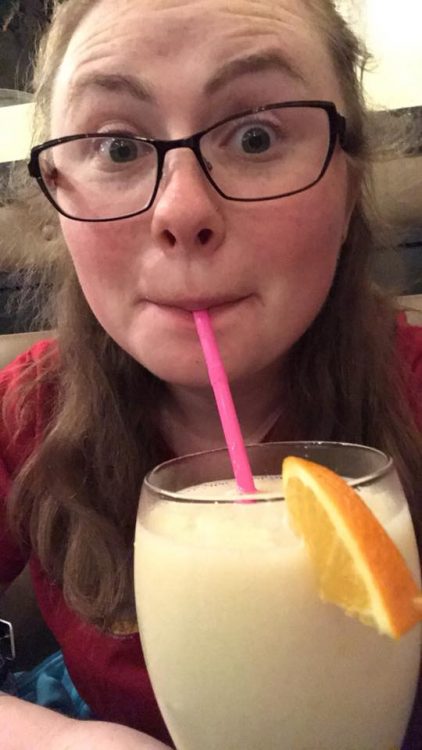 A woman drinking through a straw