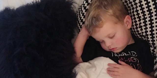 What the Journey Is Like When Your Child Has Periodic Fever Syndrome the author's boy snuggled in bed