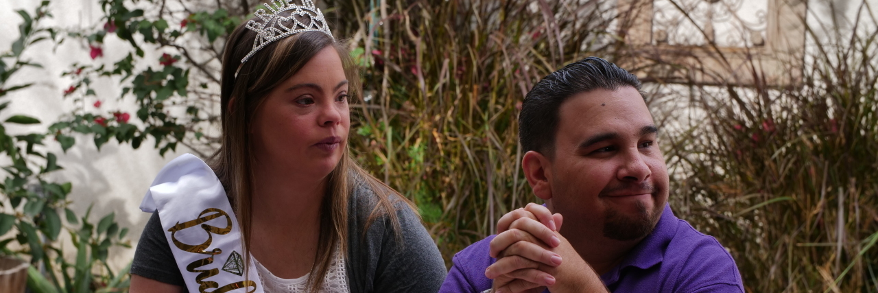 'Born This Way' Season 4, Episode 1 Recap: 'Pursuit of Happiness' Cristina wearing a tiara and a sash that says, "bride to be" sitting by Angel.