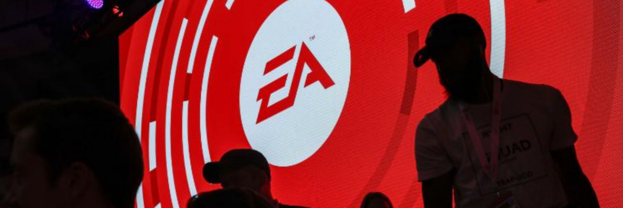 Twitter Responds to Jacksonville Shooter's Psychiatric Hospitalization Large screen that has the EA sports logo with silhouettes of people in front of it.