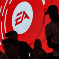 Large screen that has the EA sports logo with silhouettes of people in front of it.