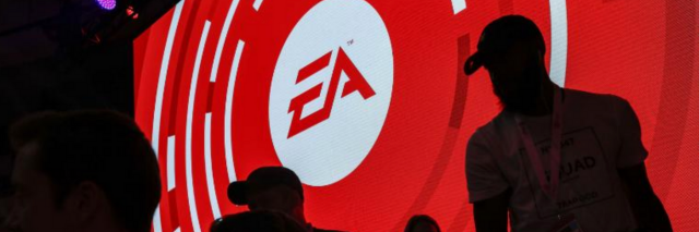 Large screen that has the EA sports logo with silhouettes of people in front of it.