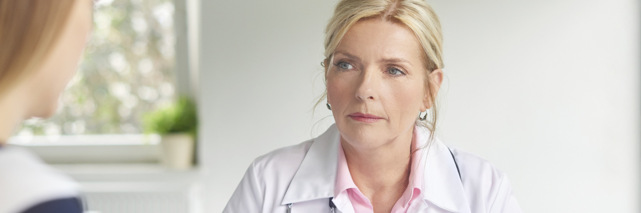 The Problematic Way Doctors Are Responding to My Autoimmune Disease A picture of a female doctor talking to a female patient.