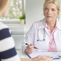 A picture of a female doctor talking to a female patient.