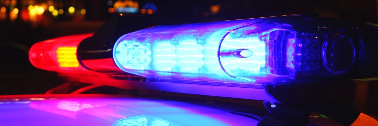 The Time I Had to Talk to Police as a Man With Autism Police lights at night.