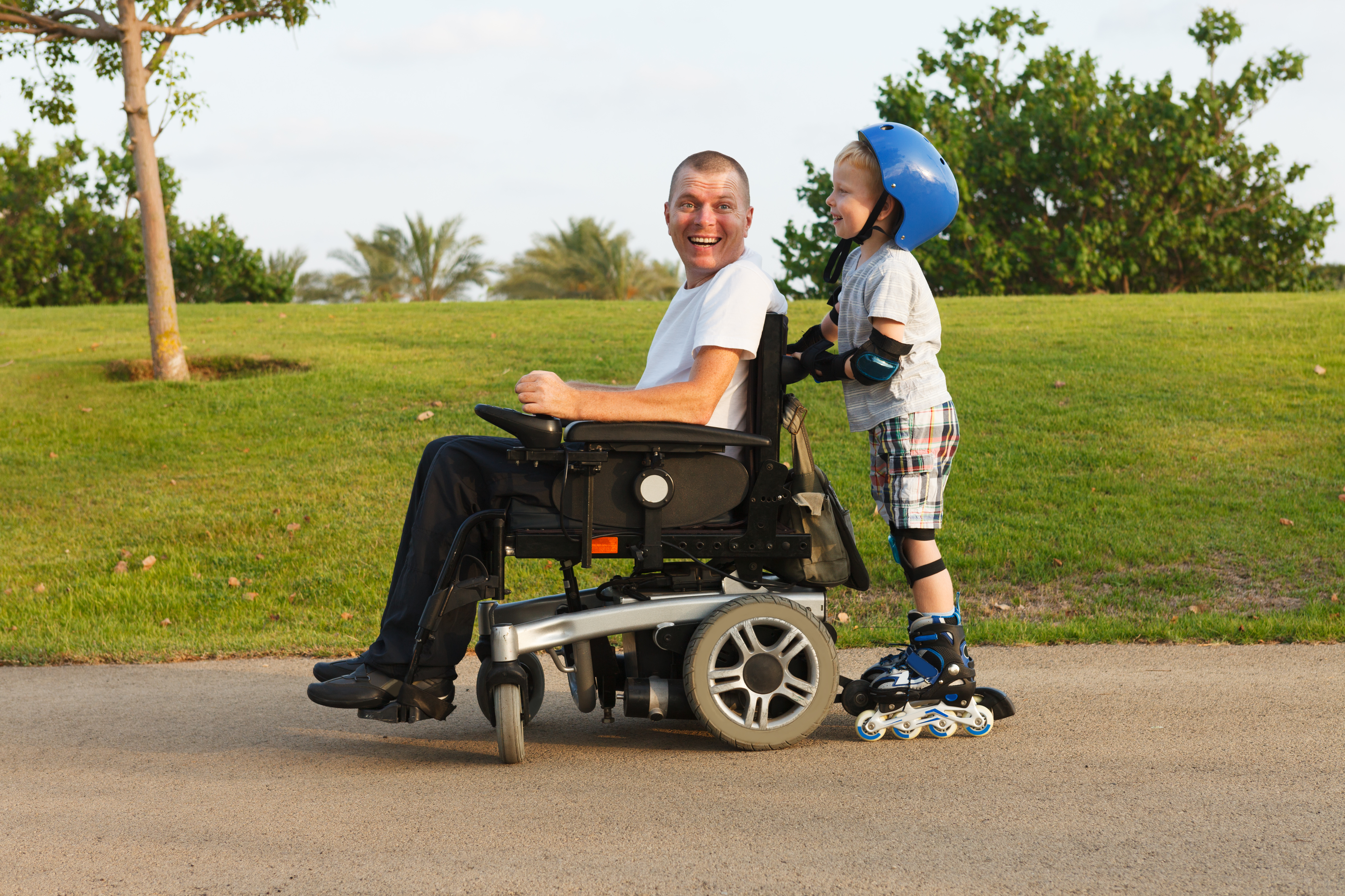 Disabled father rollerblading with son.
