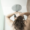 photo of woman in shower washing her hair