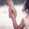 child holding mother's hand