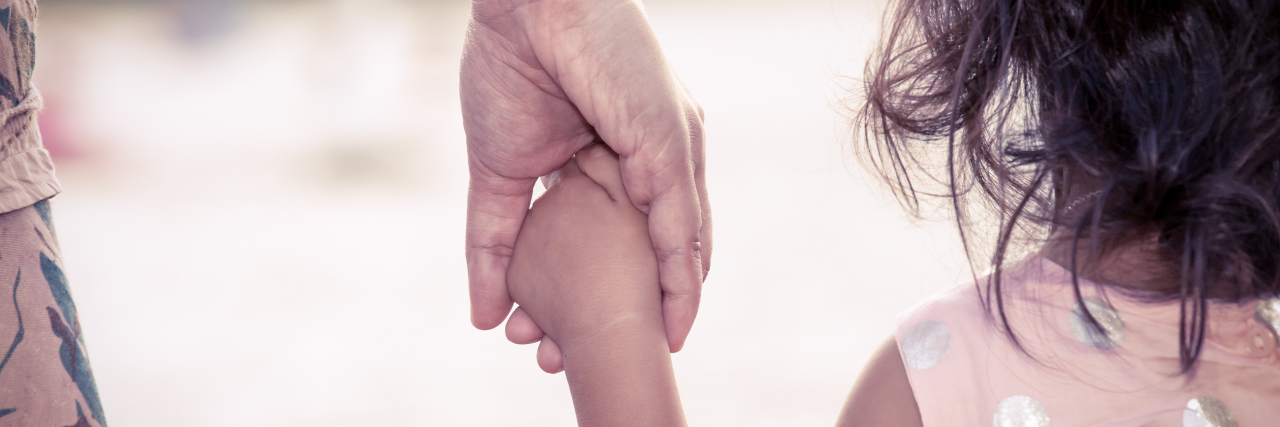 What to Know: Parenting a Child With Persistent Fetal Vasculature child holding mother's hand