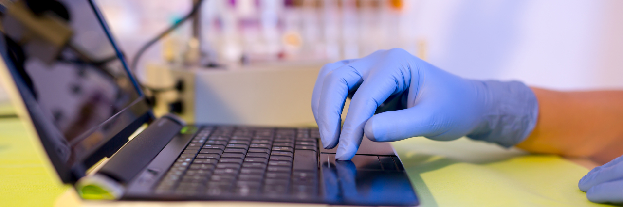 Why I Believe 'Real' Hope Is in Multiple System Atrophy Research A scientist working on a laptop