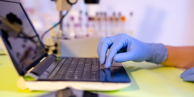 A scientist working on a laptop