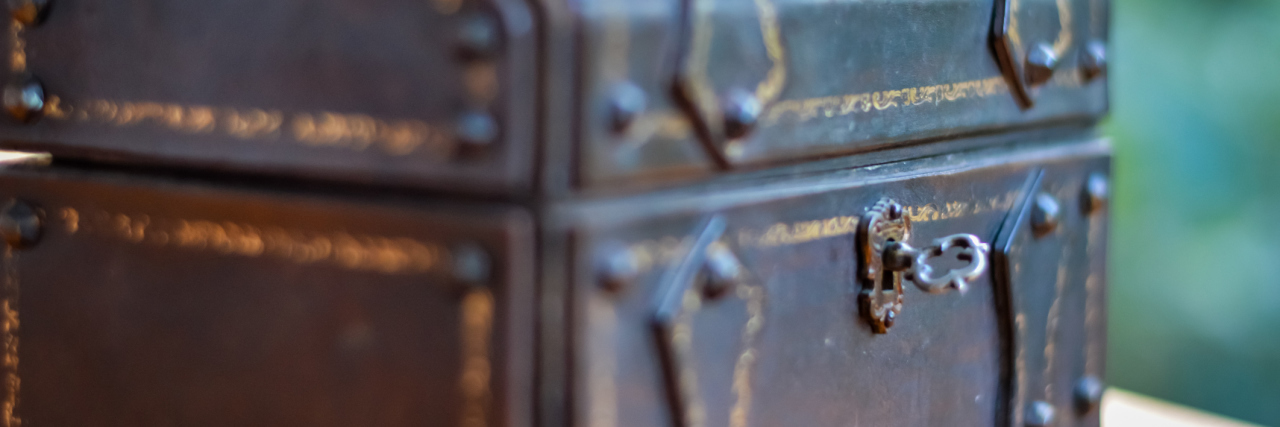 I'm Feeling Sick Again and Now It's Time to Open Pandora's Box A photo of an old wooden chest with a key inside the lock.