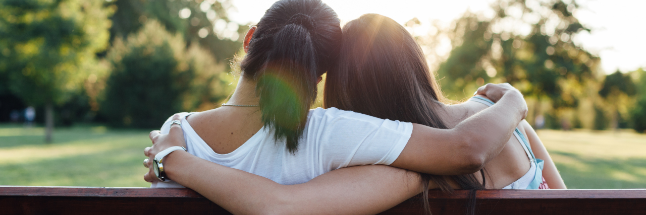 When a Stranger Diagnosed My Ehlers-Danlos Syndrome Closeup of women embracing on a park bench