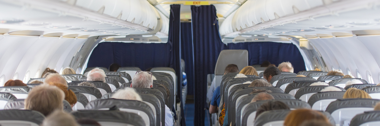 Lawsuit Seeks to Require Accessible Restrooms on More Airplanes Commercial aircraft cabin with passengers.