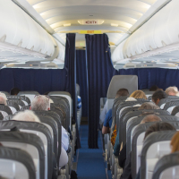 Commercial aircraft cabin with passengers.
