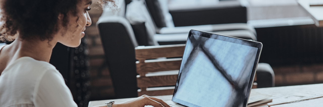 Advice for Having Lupus and a Job Rear view of woman using computer while sitting in cafe