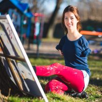 Woman without arms painting with her foot.