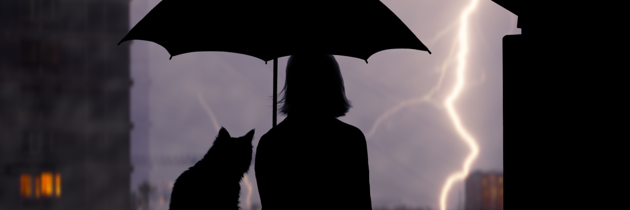 When You Get a Diagnosis and the 'Honeymoon Period' of Relief Ends A silhouette of a woman and cat outside, under an umbrella, watching a lightening storm.